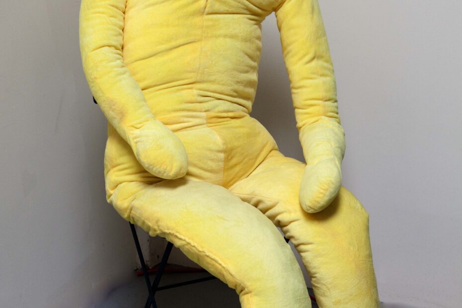 fuzzy yellow stuffed man doll is 6'7" with button eyes